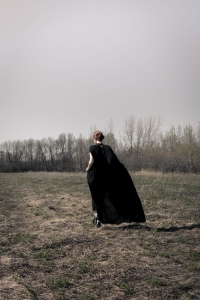Woman wearing long black dress in nature