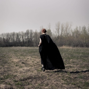 Woman wearing black dress in nature