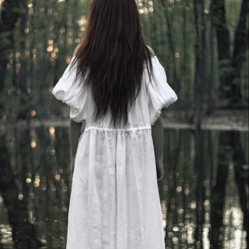 Woman in water wearing white organic dress