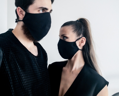 Man and woman waring organic black face masks