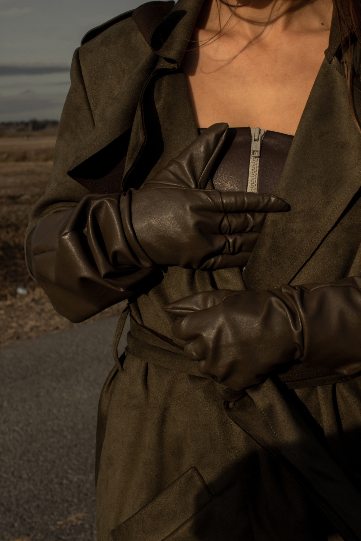 Woman wearing medieval faux leather gauntlet gloves in cedar brown
