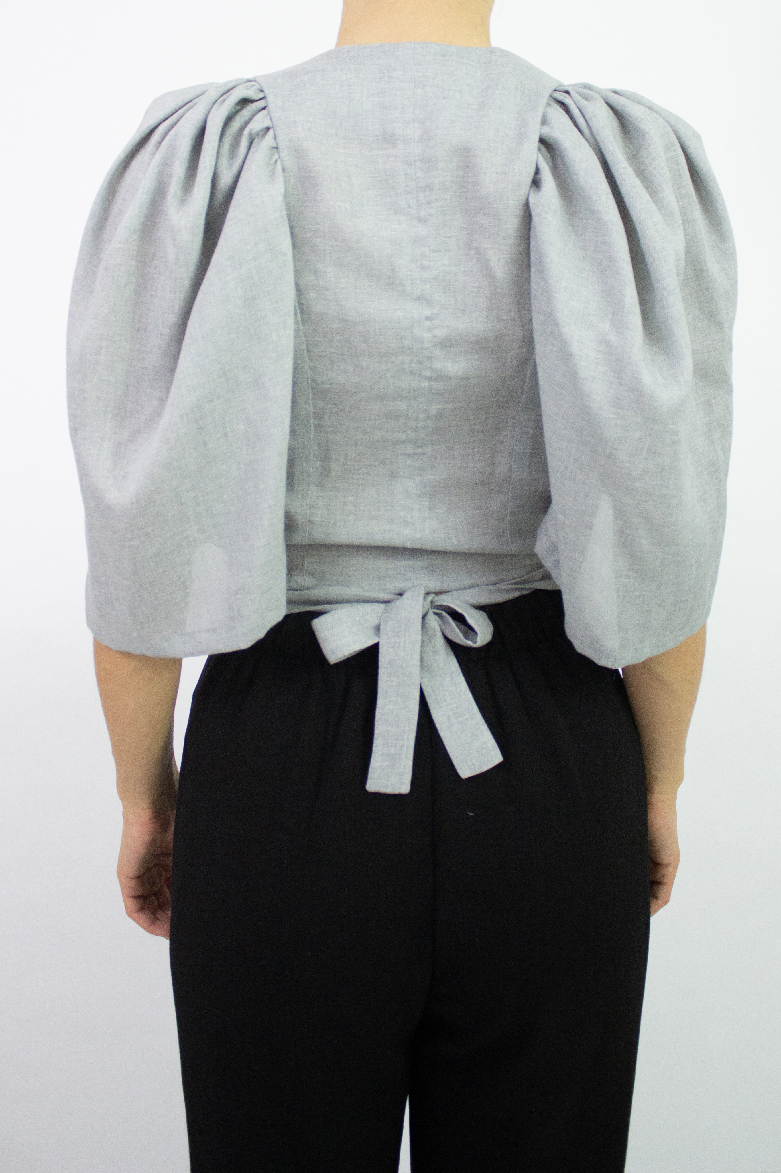 Woman wearing grey tie top