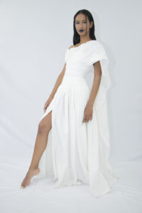Woman wearing white organic cotton pleated wedding dress