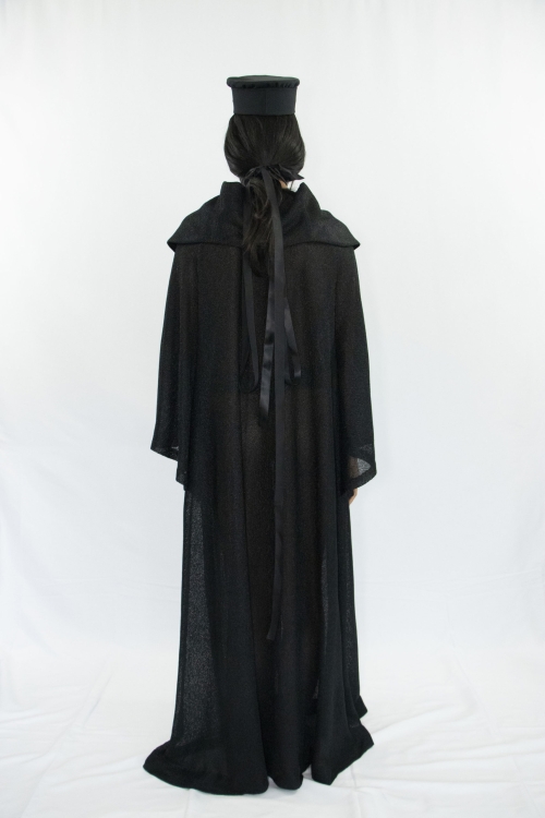 Woman wearing black sheer a-line dress with cape collar