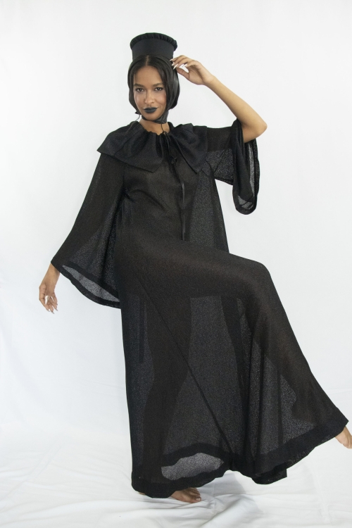 Woman wearing black sheer a-line dress with cape collar