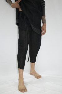 Man wearing three-quarter sheer mesh pants with front pocket