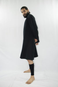 Man wearing organic long black unisex tunic with turtleneck and long sleeves