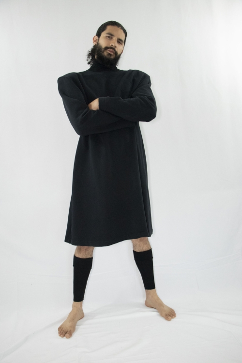 Man wearing organic long black unisex tunic with turtleneck and long sleeves