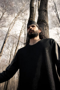 Man wearing black tunic in the woods