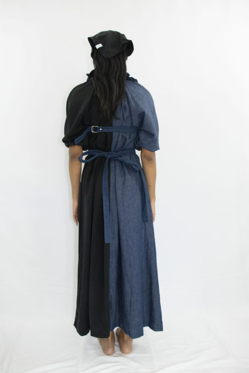 Woman wearing black and blue long a-line dress with ruff collar and gathered kimono sleeves made from organic hemp, cotton and sustainable lyocell