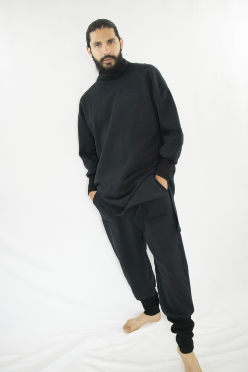 Man wearing organic black unisex tunic with long sleeves and high collar
