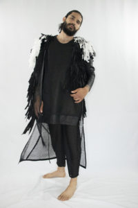 Man wearing black unisex vest made out of cotton, linen and lyocell fringes fron zero waste materials
