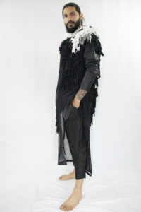 Man wearing black unisex vest made out of cotton, linen and lyocell fringes fron zero waste materials