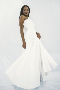 Woman wearing organic cotton pleated bridal dress in white