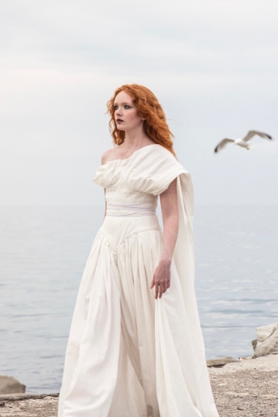 Woman wearing organic cotton pleated bridal dress in white